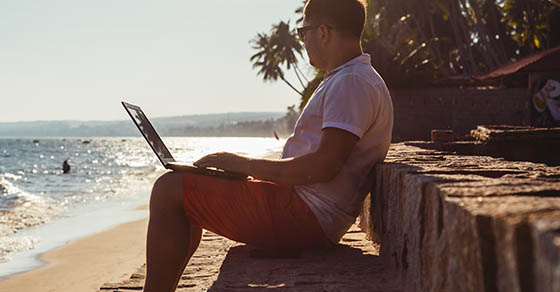 Man on beach with laptop, Vietnam, Mui Ne