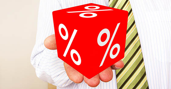 Man holds cubes with percent sign