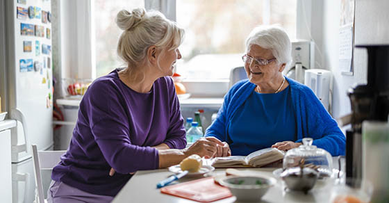 Woman spending time with her elderly mother at home